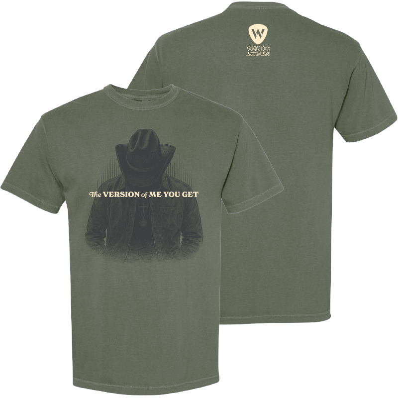 Green t-shirt with a graphic of a person wearing a cowboy hat and text on the front, and a logo on the back.