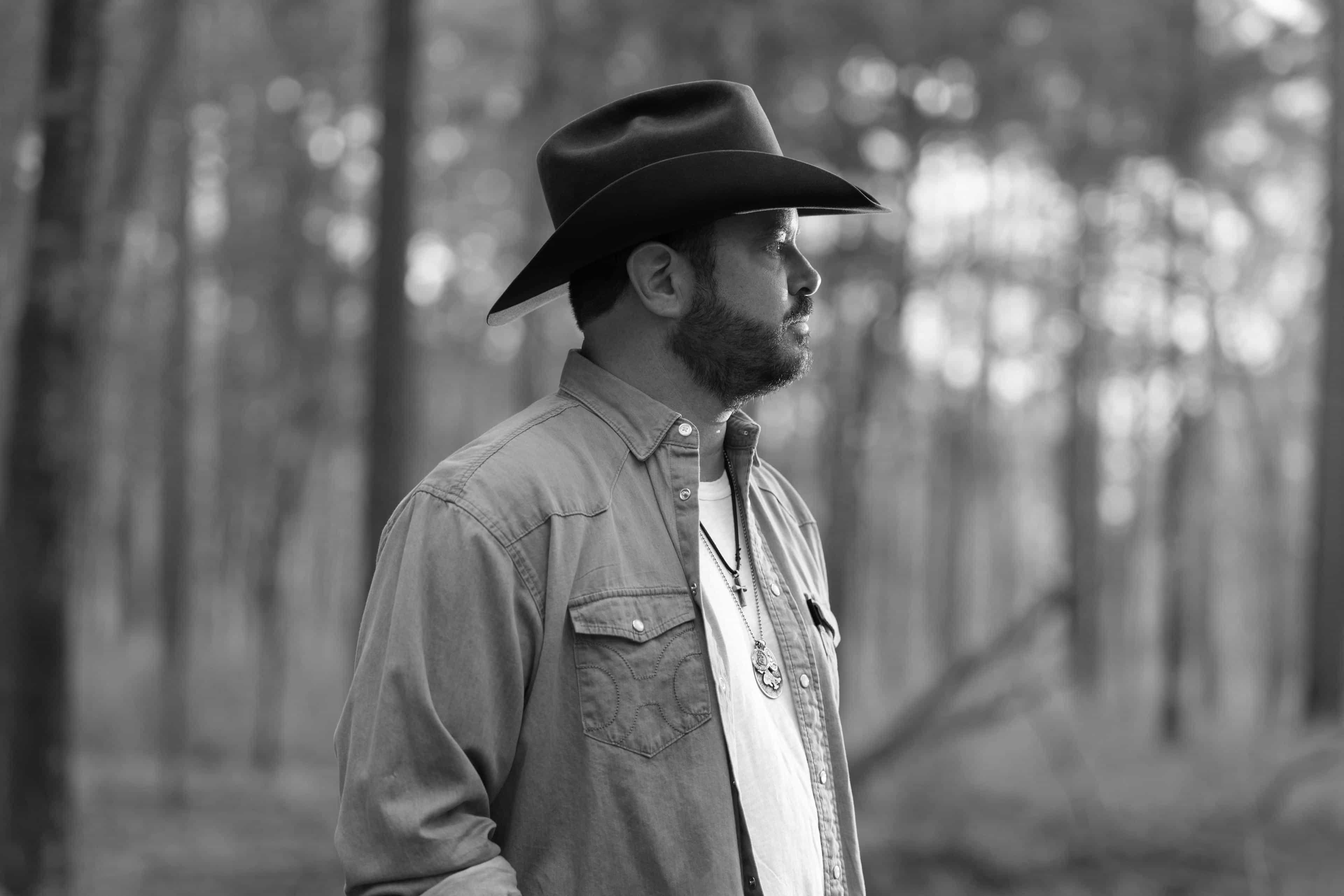Black and white photo of Wade in a forest with a blurry background